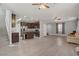 Open floor plan with modern kitchen, island, and stainless steel appliances with hardwood floors and gray walls at 626 Taliput Palm Pl, Henderson, NV 89011