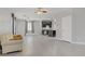 Open-concept living room and kitchen area with hardwood floors and light gray walls and dark brown kitchen cabinets at 626 Taliput Palm Pl, Henderson, NV 89011