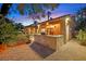 Backyard featuring an outdoor kitchen with a built-in grill, a lush lawn, and a garden at 6345 Cinnabar Ridge Ave, Las Vegas, NV 89130