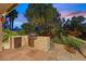 Backyard featuring an outdoor kitchen with a grill and a well-maintained lawn surrounded by landscaping at 6345 Cinnabar Ridge Ave, Las Vegas, NV 89130