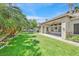 Spacious backyard featuring a covered patio and mature trees at 6345 Cinnabar Ridge Ave, Las Vegas, NV 89130