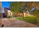 Serene backyard featuring a spacious lawn, mature trees, and ample space for outdoor entertaining at 6345 Cinnabar Ridge Ave, Las Vegas, NV 89130
