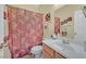 Cozy bathroom featuring a floral shower curtain, matching towels, and a vanity with storage at 6345 Cinnabar Ridge Ave, Las Vegas, NV 89130