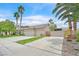 Home exterior with three-car garage and mature palm trees at 6345 Cinnabar Ridge Ave, Las Vegas, NV 89130