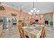 Open-concept kitchen and dining area with stainless steel appliances and granite countertops at 6345 Cinnabar Ridge Ave, Las Vegas, NV 89130