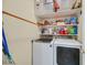 Laundry area with modern washer, dryer, and built-in shelving at 6345 Cinnabar Ridge Ave, Las Vegas, NV 89130