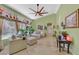 Bright living room with high ceilings, travertine flooring, large windows, and a comfortable seating area at 6345 Cinnabar Ridge Ave, Las Vegas, NV 89130