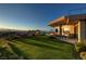 Expansive backyard with lush green lawn and outdoor dining area at 661 Dragon Peak Dr, Henderson, NV 89012