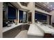 Wet bar with granite countertops offering panoramic city views at night at 661 Dragon Peak Dr, Henderson, NV 89012