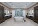Luxurious bathroom boasts a soaking tub, dual vanities, and a walk-in shower with elegant finishes at 661 Dragon Peak Dr, Henderson, NV 89012