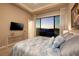 Bright bedroom with a large window view and contemporary furnishings at 661 Dragon Peak Dr, Henderson, NV 89012