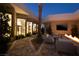 Courtyard with lounge area, fireplace, palm trees and expansive windows to living areas at 661 Dragon Peak Dr, Henderson, NV 89012