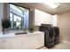 Well-lit laundry room with modern washer and dryer, and ample counter space at 661 Dragon Peak Dr, Henderson, NV 89012