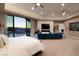 Serene primary bedroom featuring a private balcony with mountain views and a sleek fireplace at 661 Dragon Peak Dr, Henderson, NV 89012