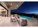 A large outdoor patio features a gorgeous pool, lounge seating and panoramic views at 661 Dragon Peak Dr, Henderson, NV 89012