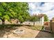 Large backyard showcasing a fire pit, lush trees, and spacious patio areas, ideal for entertaining at 7409 Central Butte Ave, Las Vegas, NV 89129
