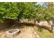 Backyard featuring a fire pit, mature trees, and ample space for outdoor gatherings and activities at 7409 Central Butte Ave, Las Vegas, NV 89129
