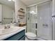 Modern bathroom with updated sink, vanity, toilet, and a glass-enclosed shower featuring white tiles at 7409 Central Butte Ave, Las Vegas, NV 89129