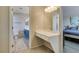 Bathroom featuring blue vanity, makeup counter, and an adjoining bedroom at 7409 Central Butte Ave, Las Vegas, NV 89129