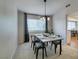 Well-lit dining area featuring modern chandelier and a view into the kitchen space at 7409 Central Butte Ave, Las Vegas, NV 89129