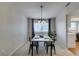 Well-lit dining area featuring modern chandelier and a view into the kitchen space at 7409 Central Butte Ave, Las Vegas, NV 89129