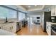 Kitchen features white cabinets, stainless steel appliances, adjacent dining, and an open view to the living area at 7409 Central Butte Ave, Las Vegas, NV 89129