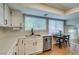Bright kitchen features white cabinets, stainless steel appliances, and adjacent dining area with lots of sunlight at 7409 Central Butte Ave, Las Vegas, NV 89129