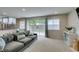 Comfortable living room featuring neutral carpet, modern furnishings, and sliding glass doors at 7409 Central Butte Ave, Las Vegas, NV 89129