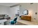 Bright living room with a neutral color scheme, large windows, and an open layout to the dining area at 7409 Central Butte Ave, Las Vegas, NV 89129