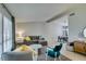 Bright living room with a neutral color scheme, large windows, and access to the dining area at 7409 Central Butte Ave, Las Vegas, NV 89129