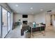 Comfortable living room with a fireplace, sliding doors to the backyard, and neutral décor at 7409 Central Butte Ave, Las Vegas, NV 89129