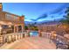 Spacious backyard featuring a built-in pool, lounge chairs and covered patio perfect for relaxation at 8204 Antler Pines Ct, Las Vegas, NV 89149