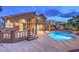 Beautiful home featuring a large pool, spa, balcony, and lush landscaping at 8204 Antler Pines Ct, Las Vegas, NV 89149