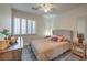 Cozy bedroom with a large window, bedside tables, and a comfortable bed at 8204 Antler Pines Ct, Las Vegas, NV 89149