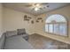 Inviting bedroom with a cozy seating area and shuttered arched window at 8204 Antler Pines Ct, Las Vegas, NV 89149