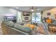 Comfortable living room with a fireplace, an aquarium and sliding glass door to the backyard pool at 8204 Antler Pines Ct, Las Vegas, NV 89149