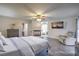Bright main bedroom with a fireplace, sitting area, and ensuite bathroom at 8204 Antler Pines Ct, Las Vegas, NV 89149