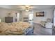 Bright main bedroom with a fireplace, ceiling fan, television, and ensuite bathroom at 8204 Antler Pines Ct, Las Vegas, NV 89149