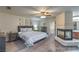Comfortable main bedroom with wood floors and a modern fireplace feature at 8204 Antler Pines Ct, Las Vegas, NV 89149
