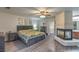 Comfortable primary bedroom boasts a fireplace, ceiling fan, and neutral decor at 8204 Antler Pines Ct, Las Vegas, NV 89149