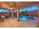 Backyard pool and spa featuring elegant tile and lush landscaping at 8204 Antler Pines Ct, Las Vegas, NV 89149