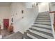 Bright foyer featuring a modern staircase with gray wood-look treads and a red front door at 8204 Antler Pines Ct, Las Vegas, NV 89149