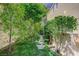 Lush backyard with a charming stone path and mature landscaping at 8221 Crow Valley Ln, Las Vegas, NV 89113