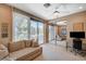 Bright bedroom with a couch, desk, and mirrored closet doors that reflect the room at 8221 Crow Valley Ln, Las Vegas, NV 89113
