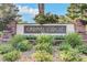 Elegant community entrance sign surrounded by manicured landscaping at 8221 Crow Valley Ln, Las Vegas, NV 89113
