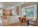 Cozy dining area adjacent to the kitchen, featuring a bay window with bench seating and modern light fixture at 8221 Crow Valley Ln, Las Vegas, NV 89113