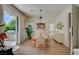 Bright dining room features an elegant table and views of the outdoor kitchen at 8221 Crow Valley Ln, Las Vegas, NV 89113