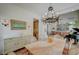 Elegant dining area with marble table, chandelier, built-in cabinet, and open layout to the living room at 8221 Crow Valley Ln, Las Vegas, NV 89113