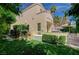 Beautiful home exterior with a well-maintained lawn and mature trees at 8221 Crow Valley Ln, Las Vegas, NV 89113