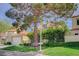 Beautiful home featuring lush green lawn, mature shade tree and landscaped front yard within a well-maintained neighborhood at 8221 Crow Valley Ln, Las Vegas, NV 89113